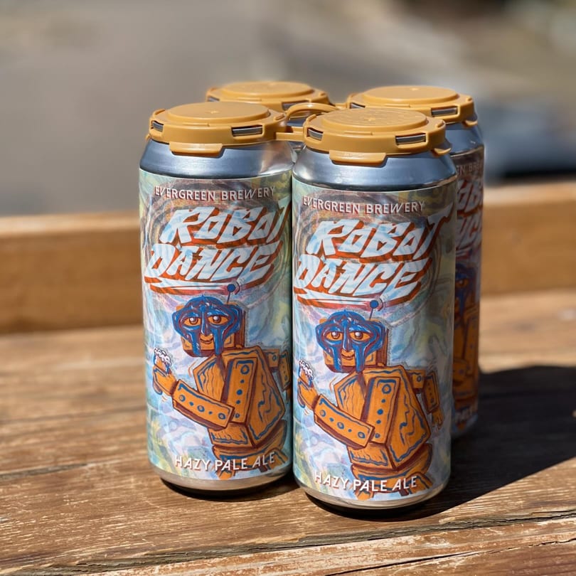 Four cans of Evergreen Brewery's "Robot Dance Hazy Pale Ale" with robot illustrations on a wooden surface.